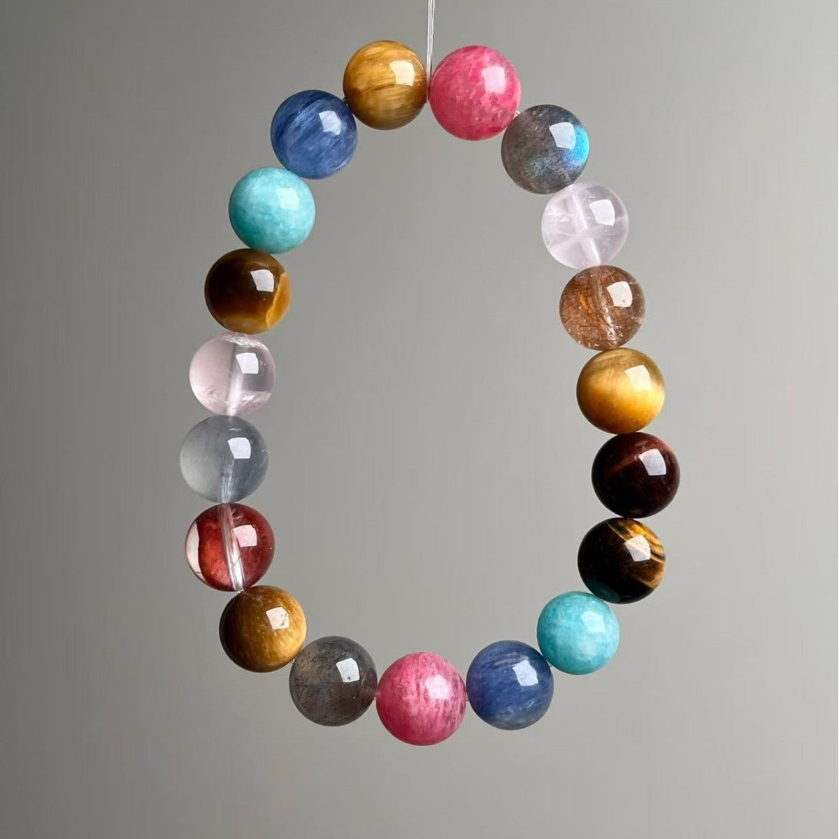Natural mixed gemstone chakra bracelet with 11mm multi-colored crystal beads