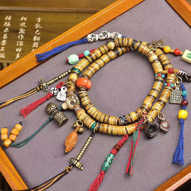 Tibetan yak bone mala close-up with Ada trinity and agate charms