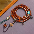 Vintage Tibetan yak bone 108 mala laid flat on display tray showing all charms