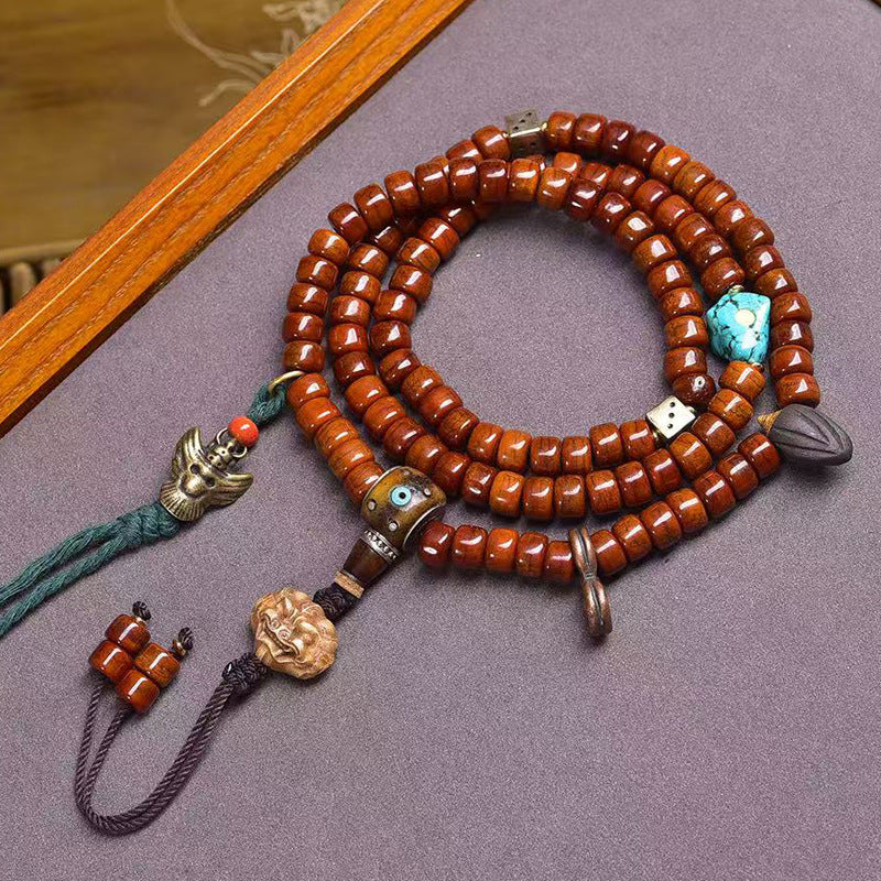 Vintage Tibetan yak bone 108 mala laid flat on display tray showing all charms