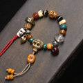 Tibetan multi-gem bone bracelet with dzi bead and red tassel