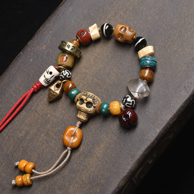 Tibetan multi-gem bone bracelet with dzi bead and red tassel