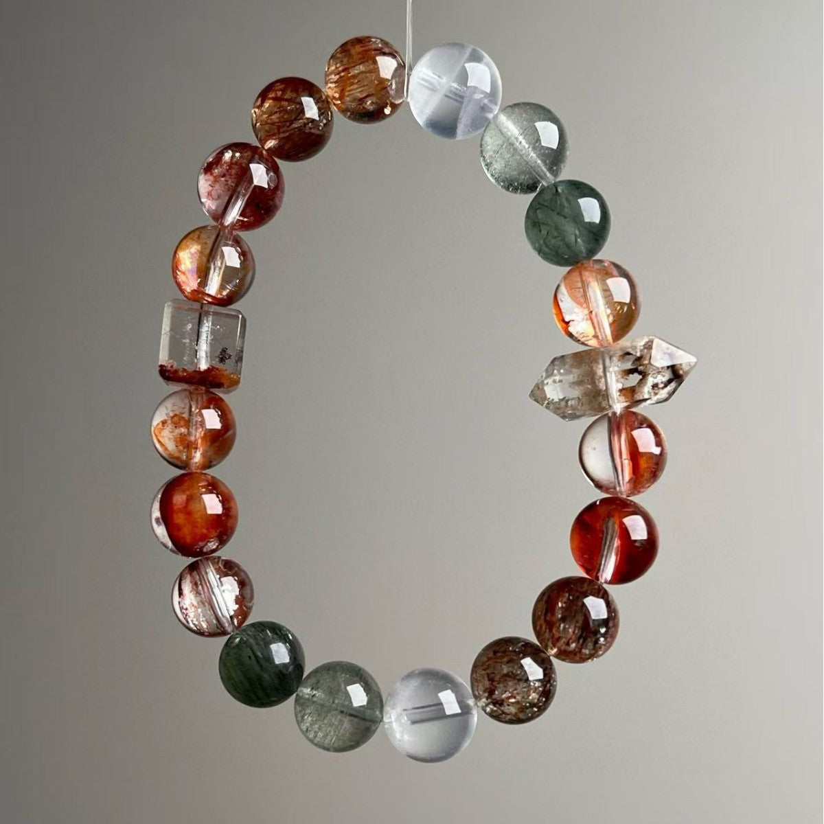 Natural Multi-Gemstone Rutilated Quartz Phantom Quartz Bracelet - Hand View