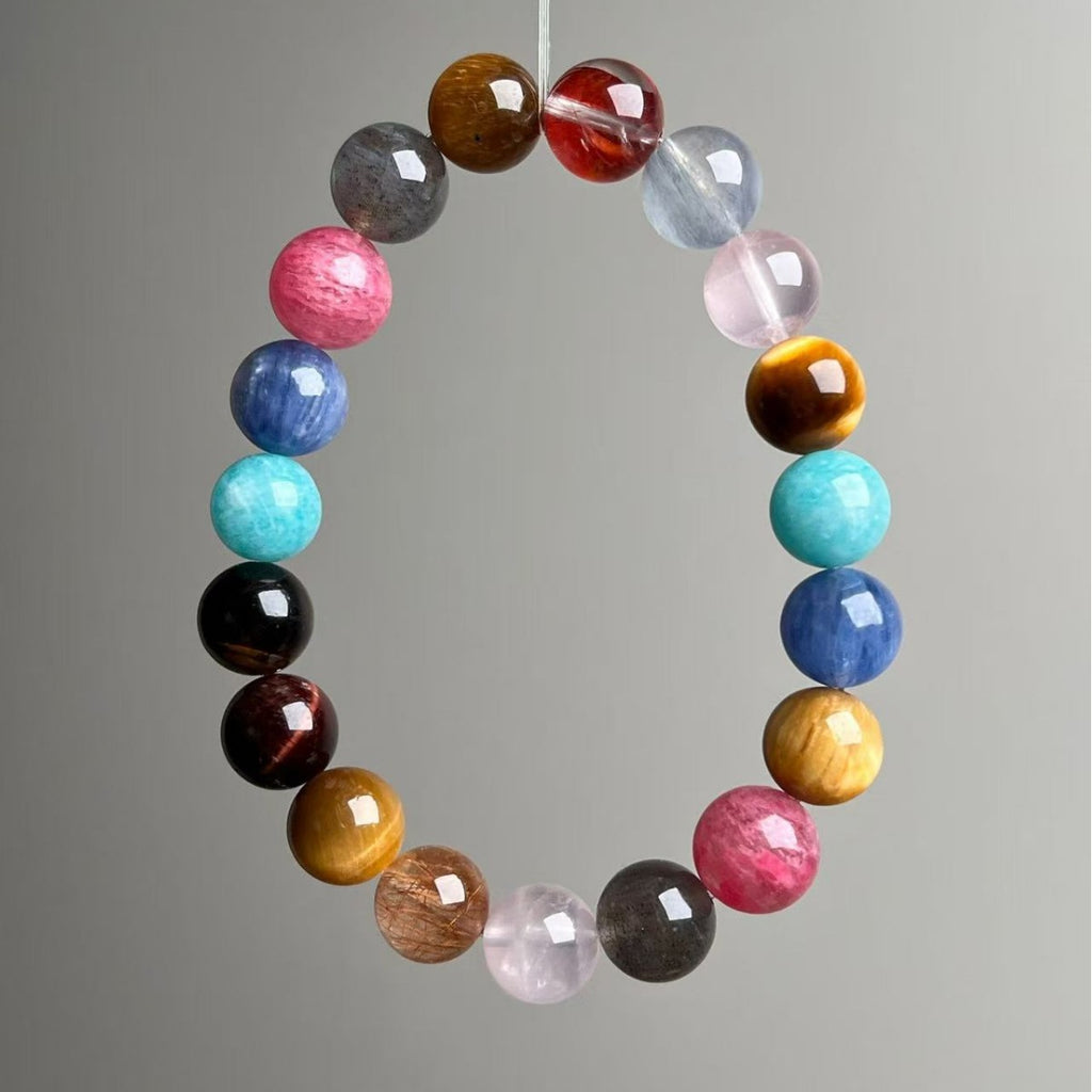 Multi-stone crystal bracelet featuring tiger's eye, amazonite, rhodonite and quartz beads