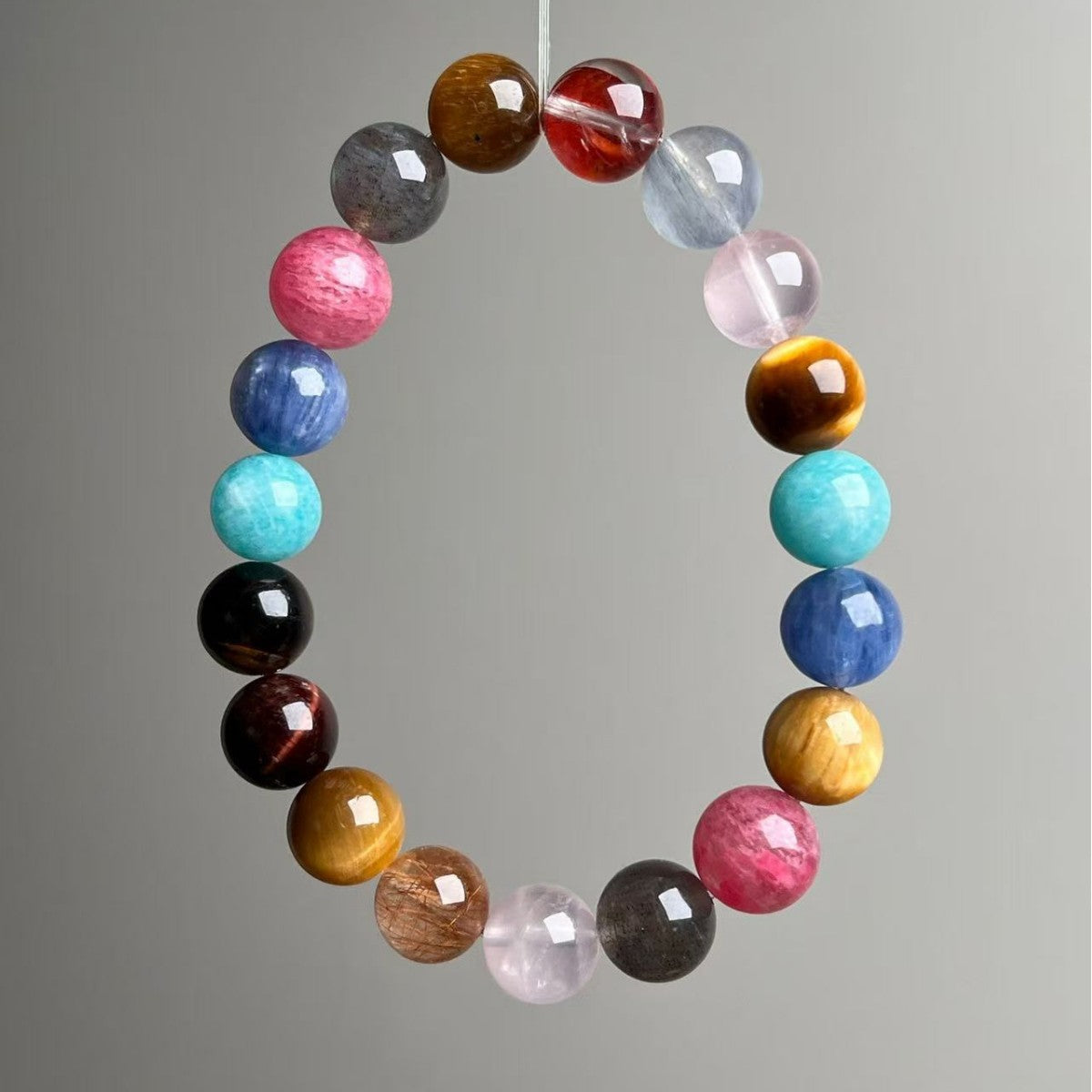 Multi-stone crystal bracelet featuring tiger's eye, amazonite, rhodonite and quartz beads