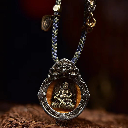 Yellow Jambhala gau box pendant necklace on wooden box