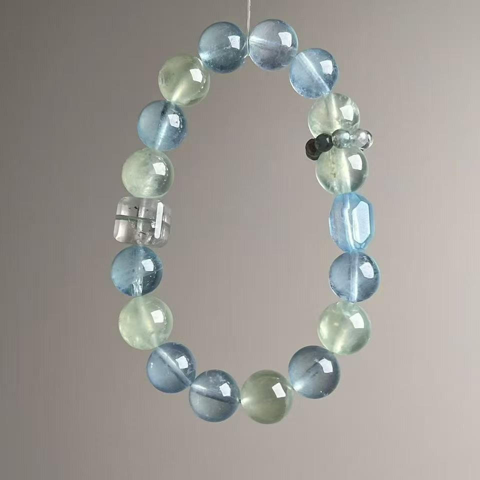Aquamarine crystal bracelet with clear quartz cube accent and gradient blue beads