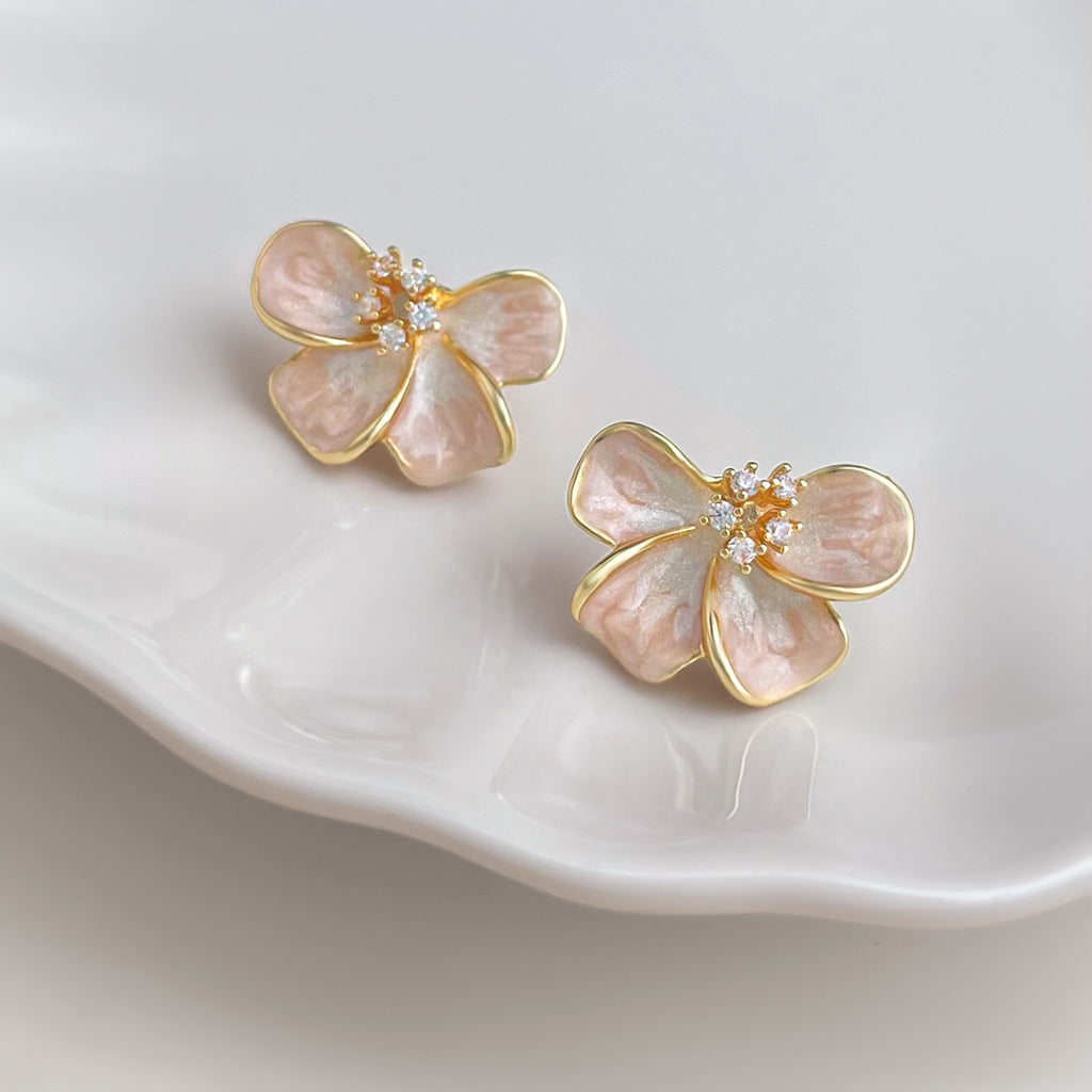 Pink gradient flower earrings with zircon center on white background