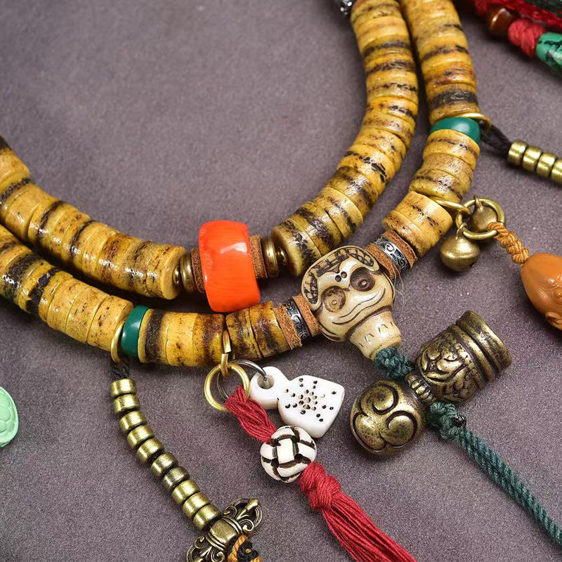 Full view of Tibetan yak bone mala with all charms on display tray