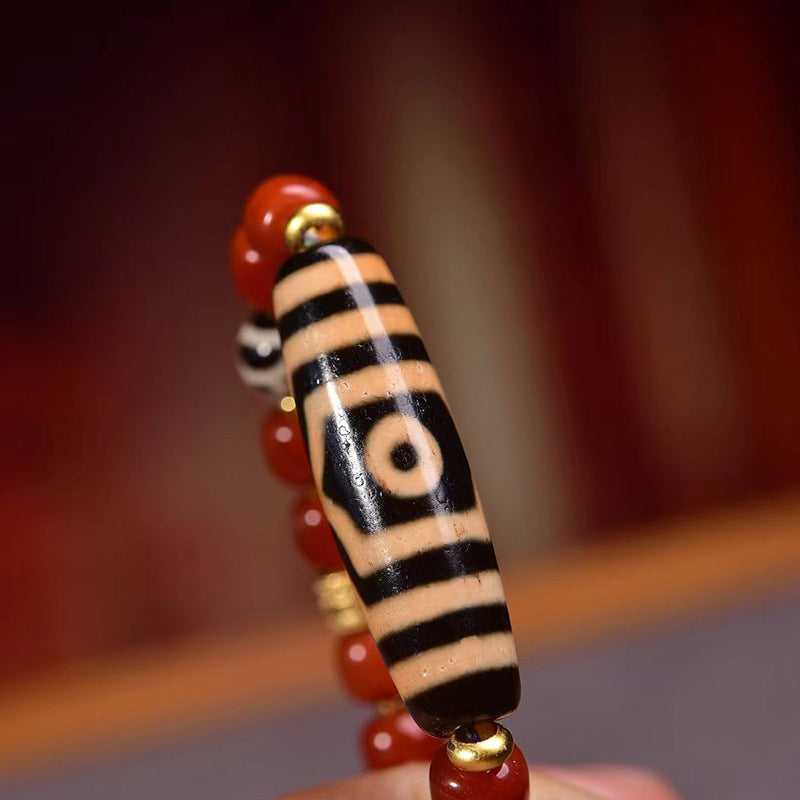Full layout of Tibetan red agate necklace on wooden surface showing complete bead arrangement and adjustable cord