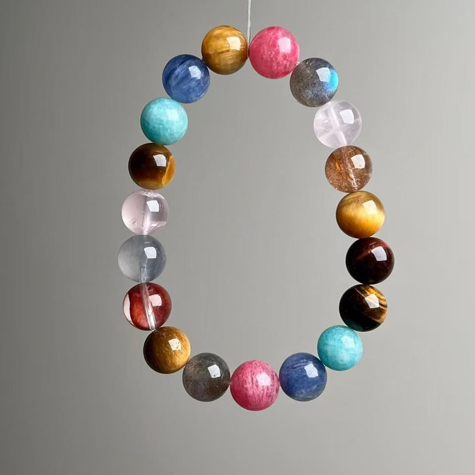 Natural assorted gemstone healing bracelet on neutral background