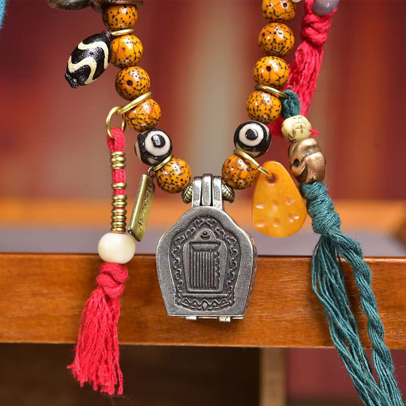 Full mala laid flat showing all charms and tassels