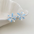 Model wearing light blue enamel firework stud earring