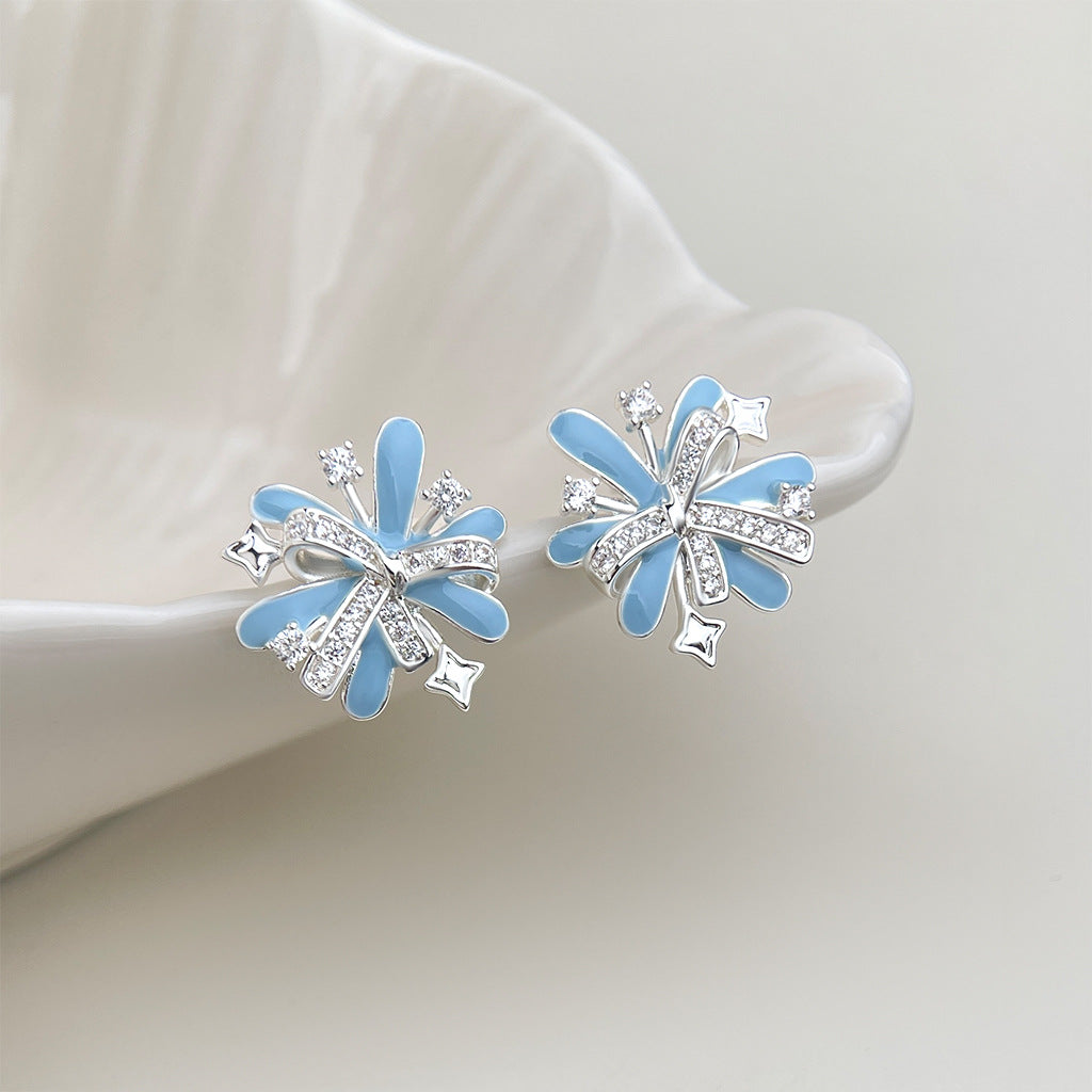 Model wearing light blue enamel firework stud earring