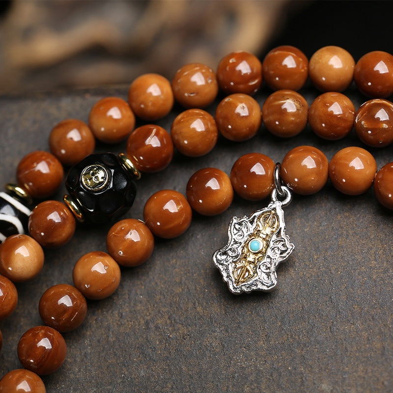 Full cook seed mala laid flat showing all charms and tassels