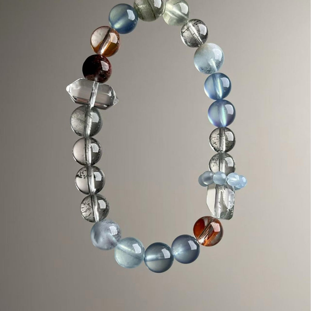 Handmade Brazilian crystal bracelet with aquamarine and quartz beads on neutral background