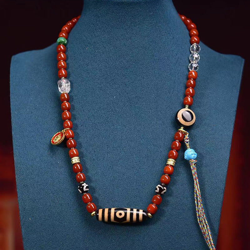 Tibetan red agate dzi bead necklace styled on mannequin bust showing long sweater chain wearing length