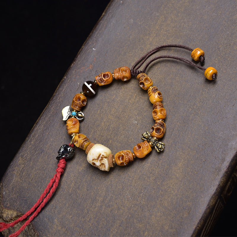 Full yak skull mala bracelet with red tassel