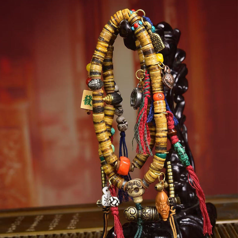 Tibetan yak bone mala laid flat on display tray showing all pendants