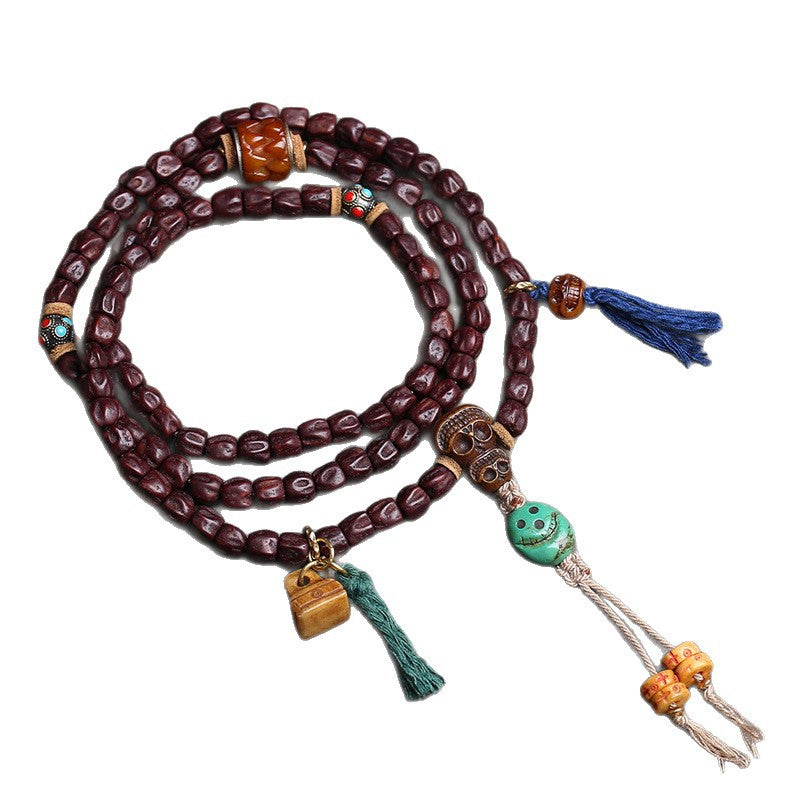 Full view of red sandalwood 108 mala on white background showing all pendants and tassels