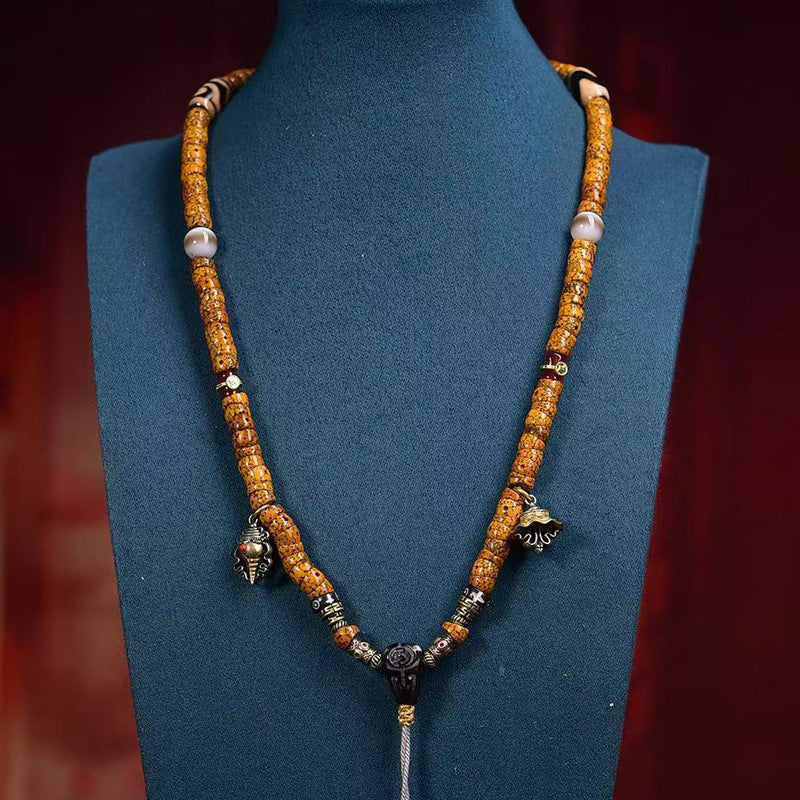 Crescent star bodhi 108 mala worn as necklace on mannequin bust showing full drape and charms