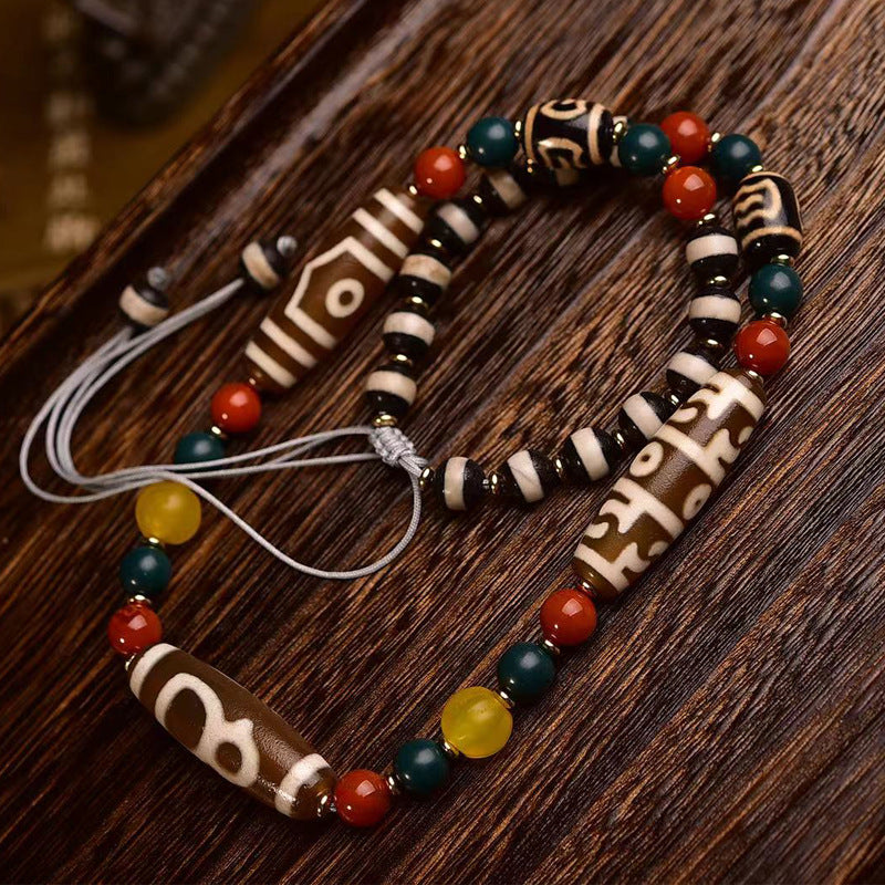 Multi-stone dzi bead necklace with enamel charm on blue bust